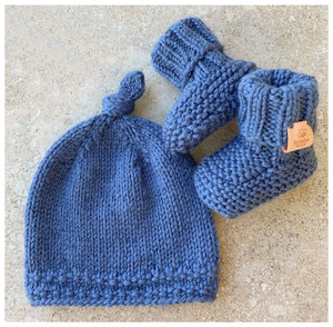 hand knitted top knot hat and matching booties, denim colour, sizes 0-12 months. softest australian merino wool, stay on booties